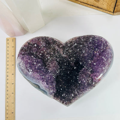 amethyst heart next to a ruler for size reference