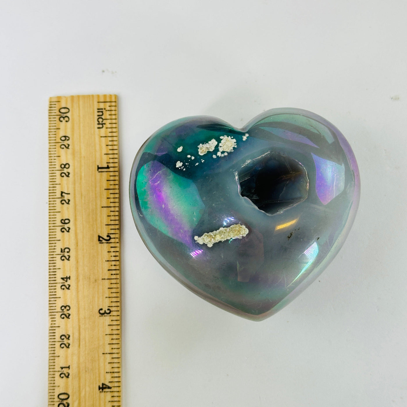 aura agate hearts next to a ruler for size reference