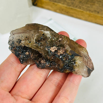 rutilated quartz with decorations in the background