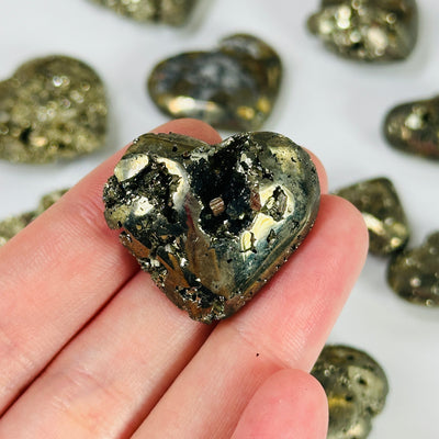 pyrite heart with decorations in the background