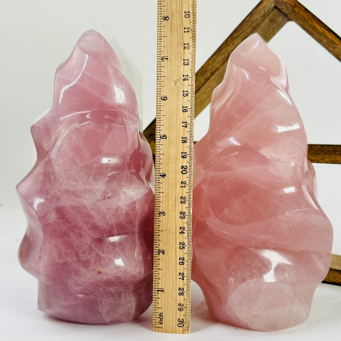 rose quartz flame tower next to a ruler for size reference