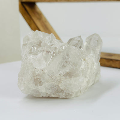 crystal quartz cluster with decorations in the background