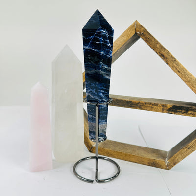 sodalite point with decorations in the background