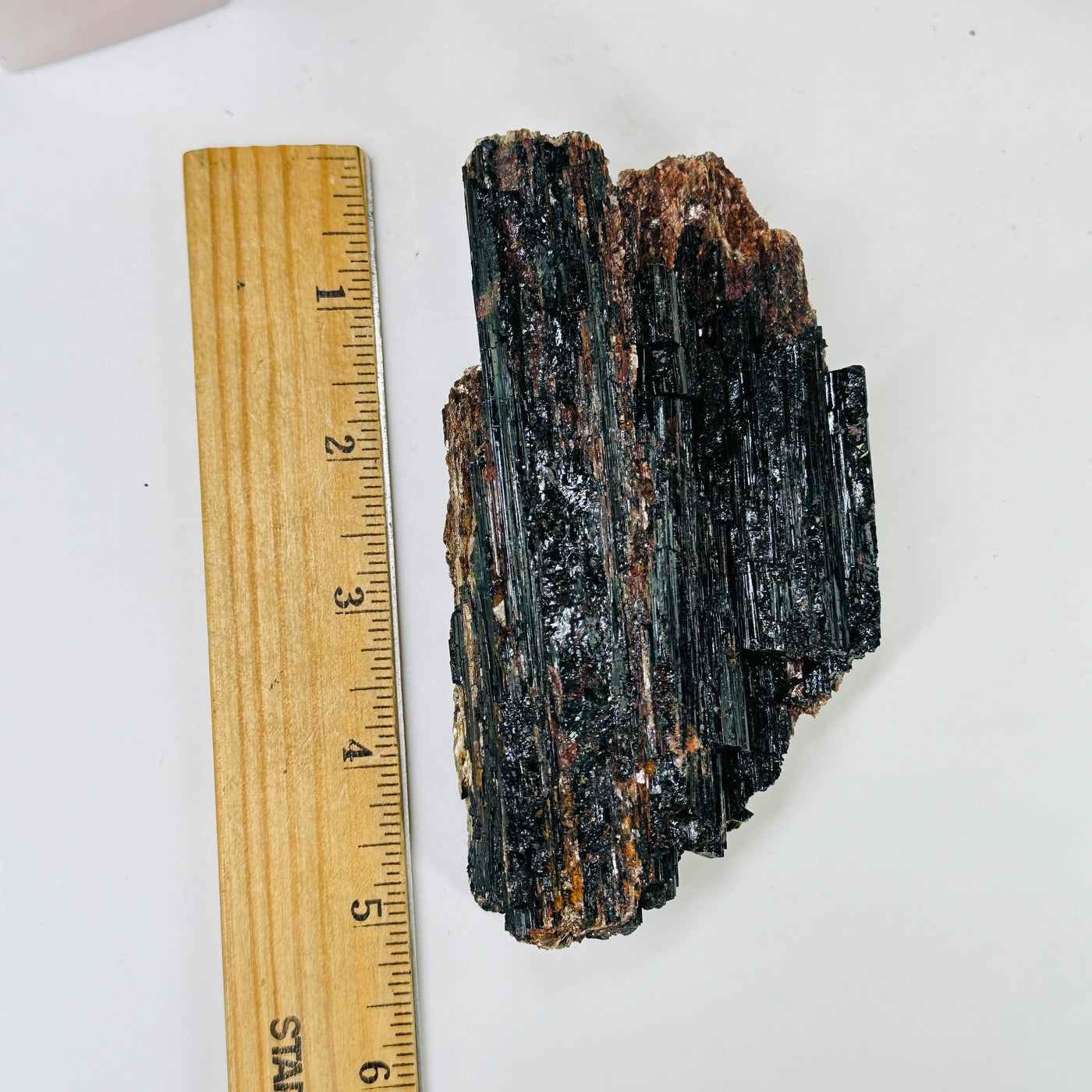 tourmaline cluster next to a ruler for size reference