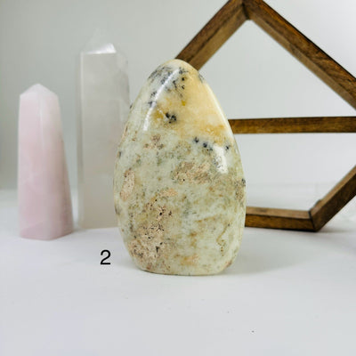 Dendrite opal cut base with decorations in the background