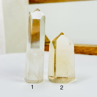 crystal quartz point with decorations in the background