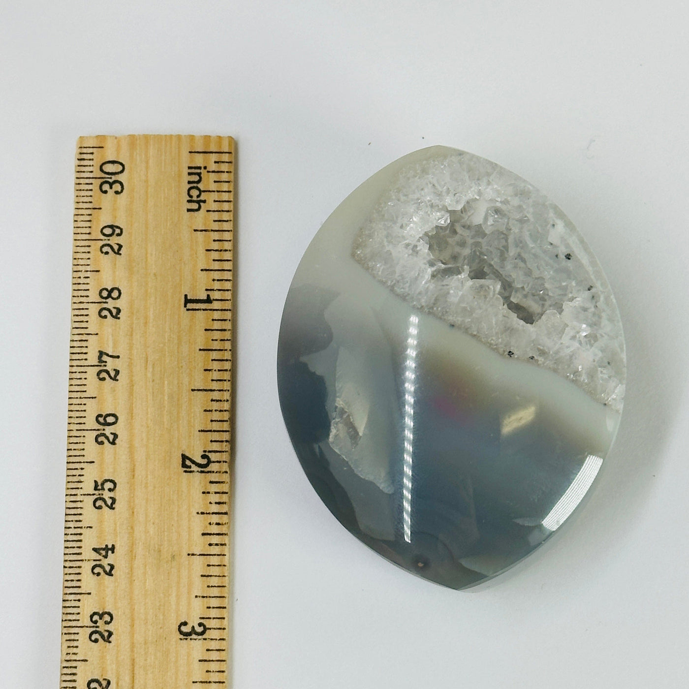 agate marquis decoration next to a ruler for size reference