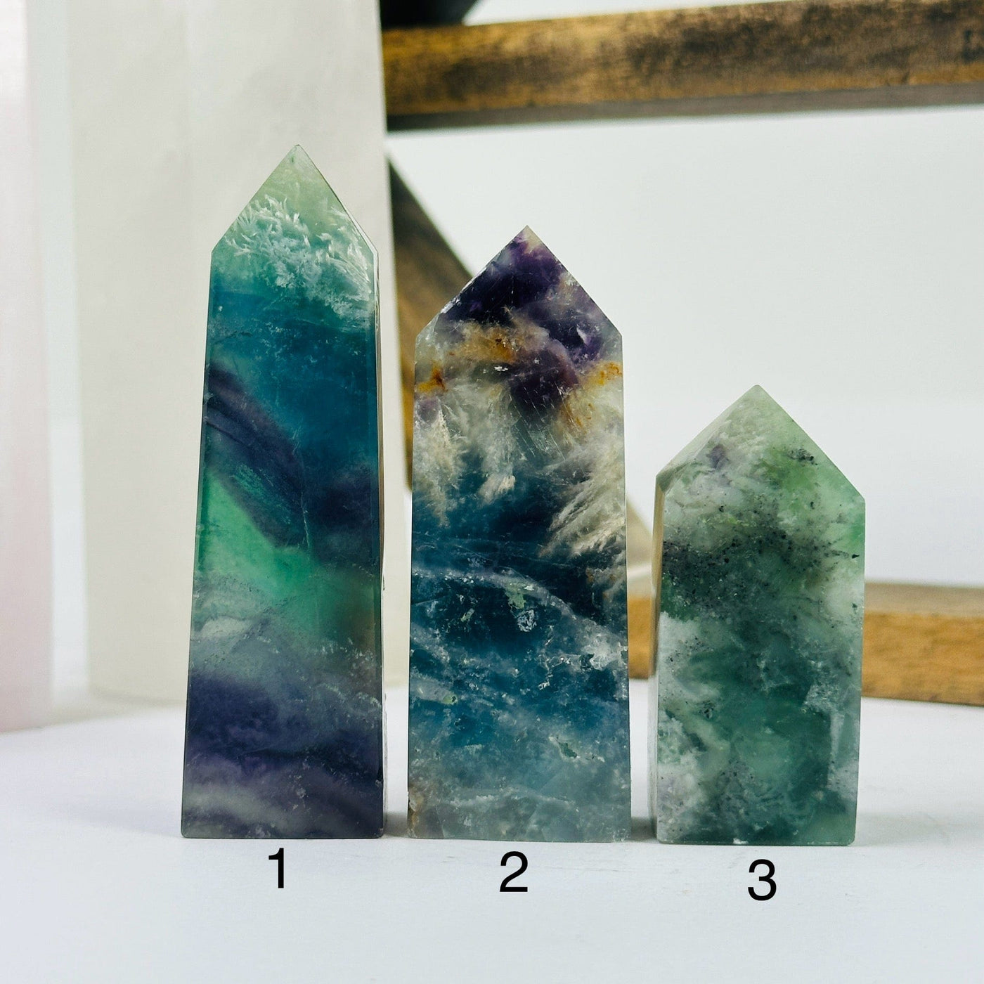 fluorite point with decorations in the background