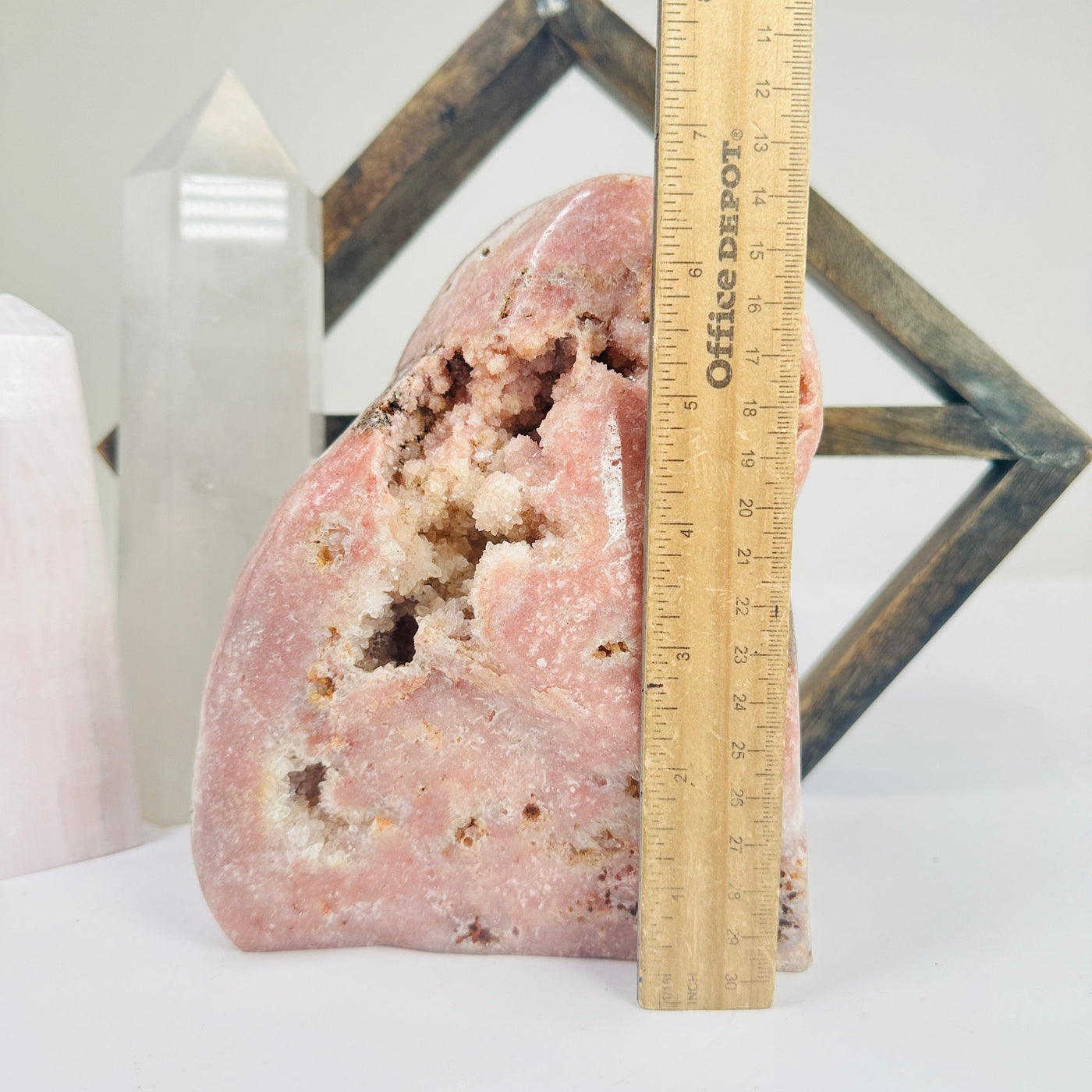 pink amethyst cut base next to a ruler for size reference