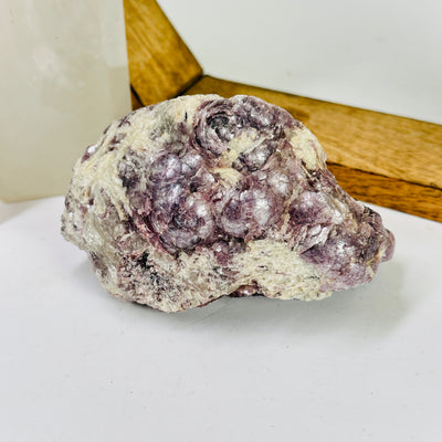 lepidolite with decorations in the background