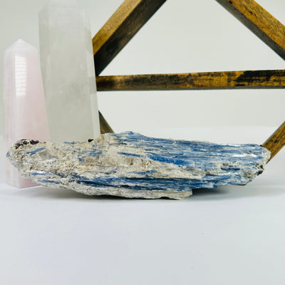 Kyanite with decorations in the background