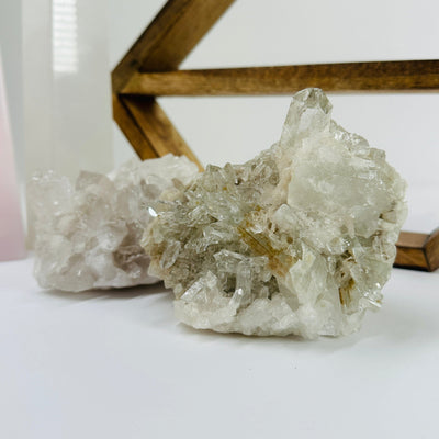 crystal quartz cluster with decorations in the background