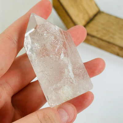 crystal quartz point with decorations in the background
