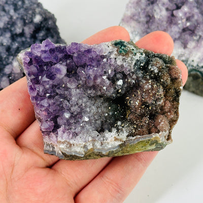 amethyst cluster with decorations in the background