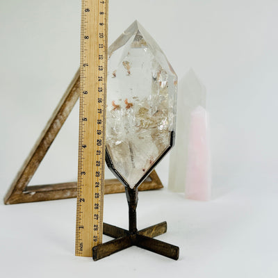 lodalite on metal stand next to a ruler for size reference