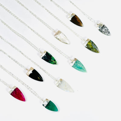 gemstone necklaces on white background