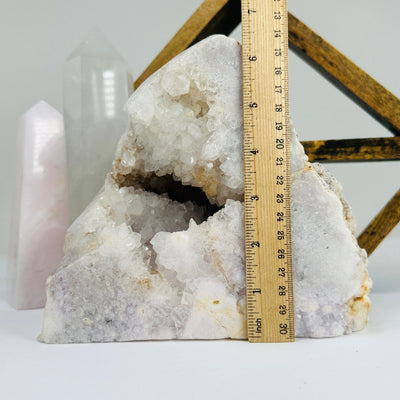 pink amethyst cut base next to a ruler for size reference