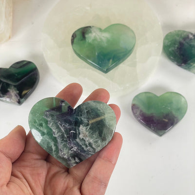 Rainbow Feathered Fluorite Crystal Heart - You Choose one in hand for size reference with others in the background