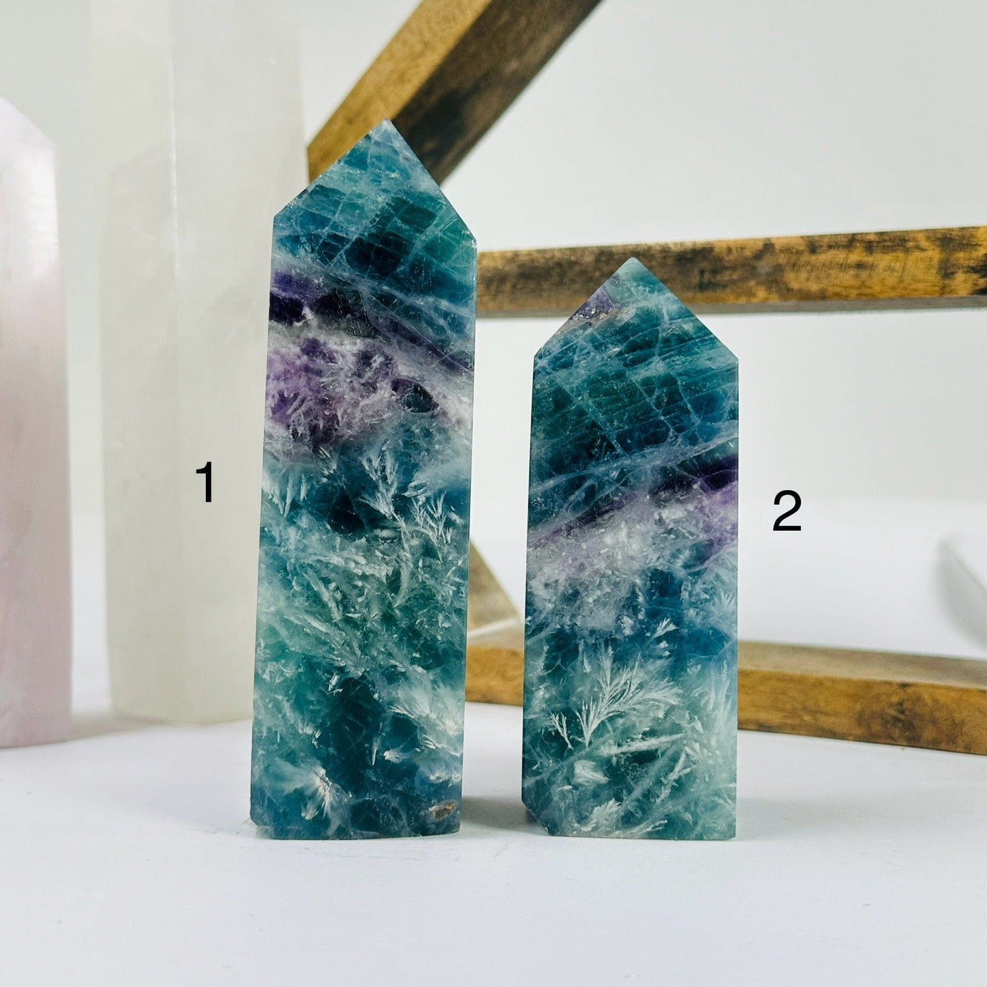 fluorite point with decorations in the background