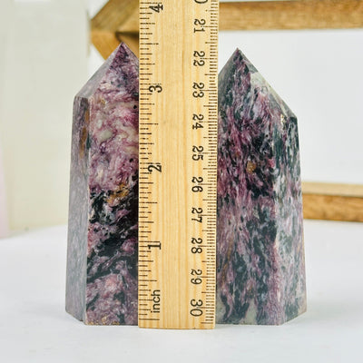 charoite points with decorations in the background