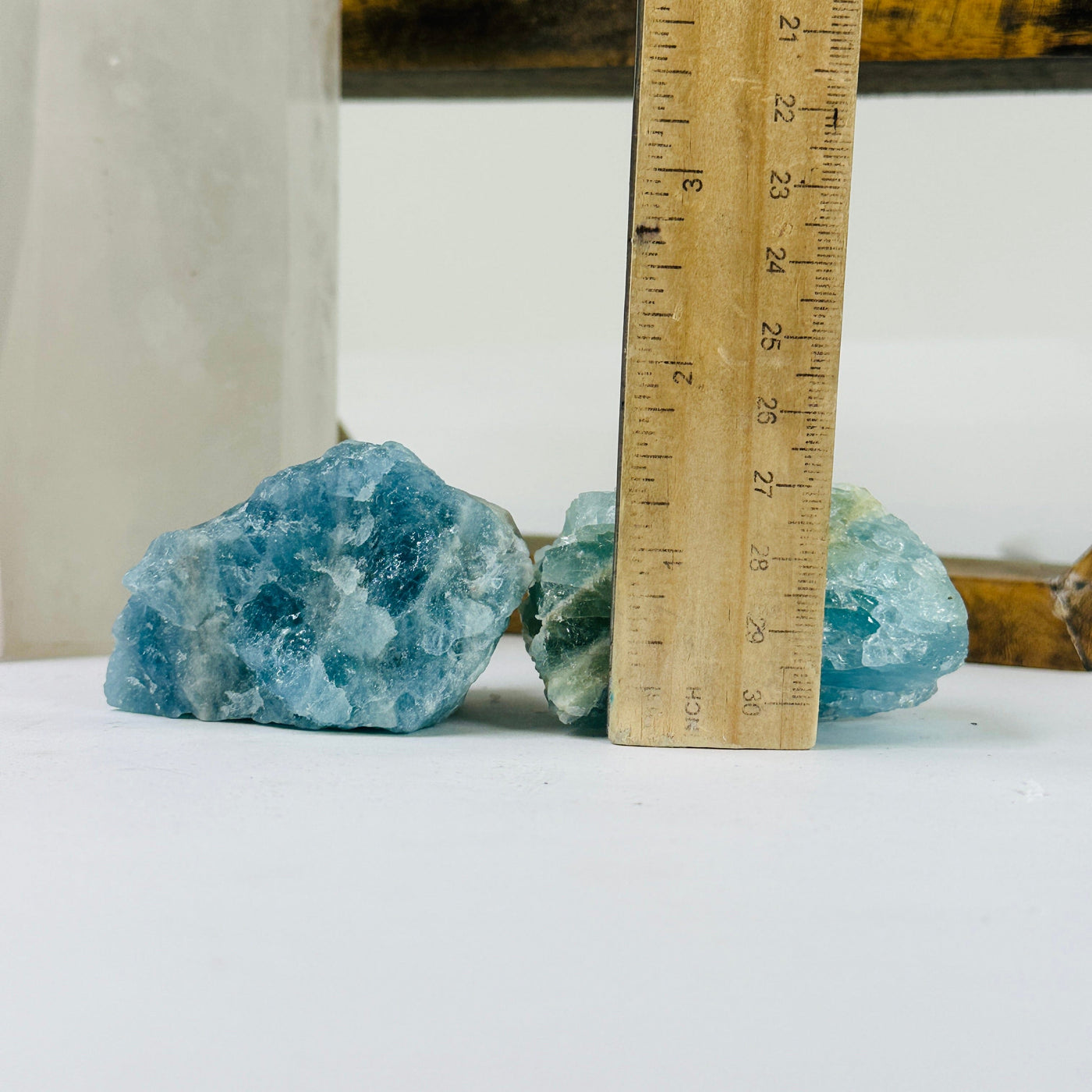 aquamarine stone next to a ruler for size reference