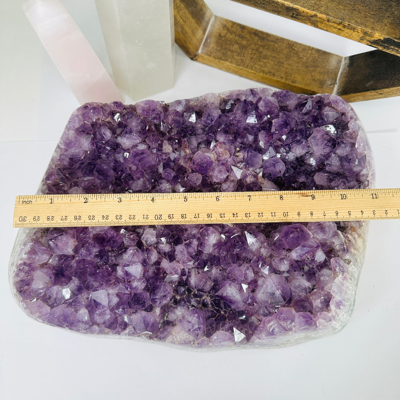 amethyst cluster with decorations in the background