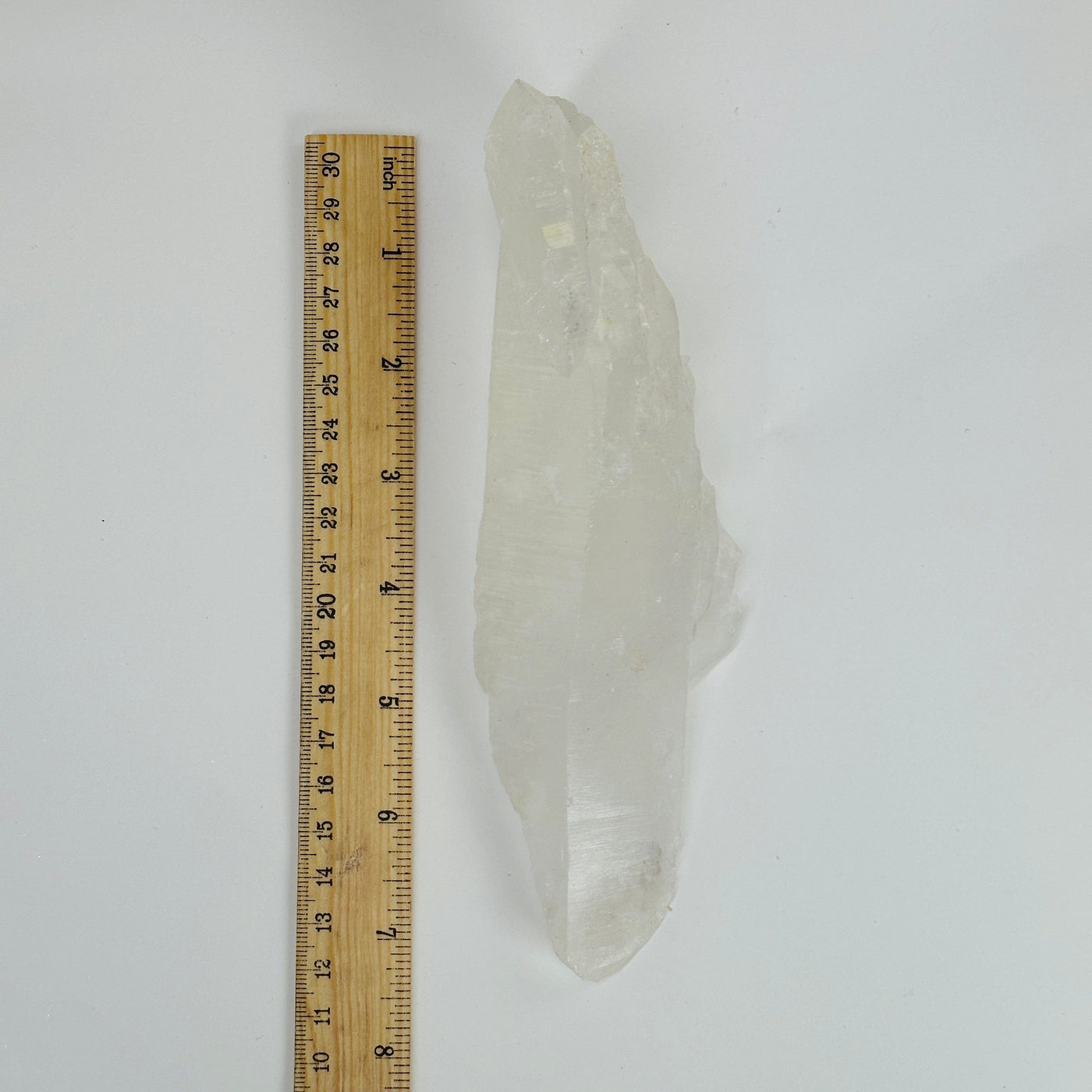 crystal quartz next to a ruler for size reference