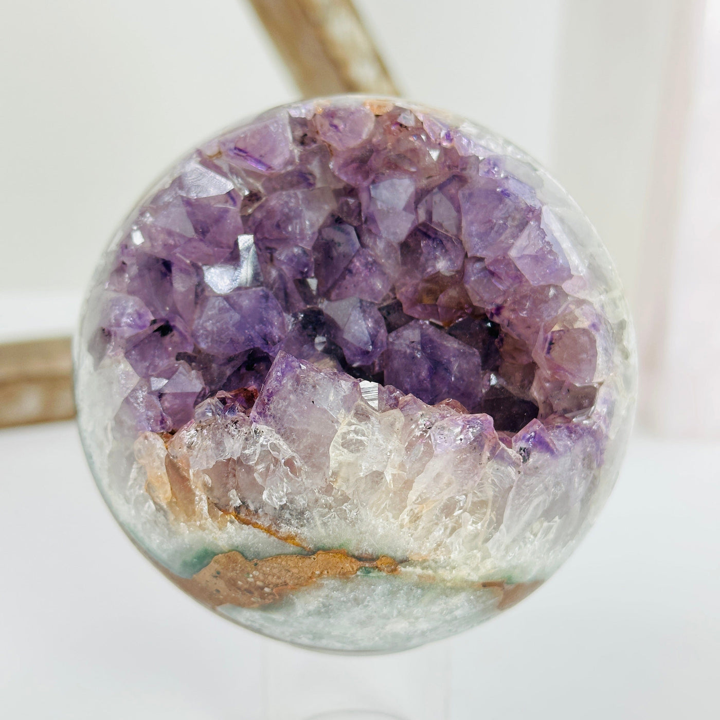 amethyst sphere with decorations in the background