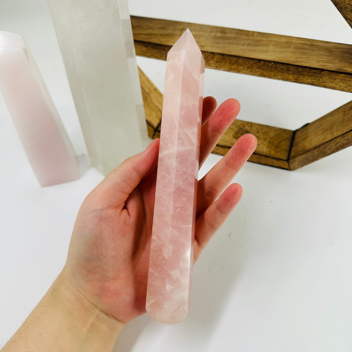 rose quartz massage wand with decorations in the background