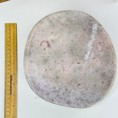 pink amethyst bowl next to a ruler for size reference