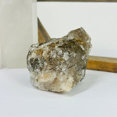 rutile quartz with decorations in the background