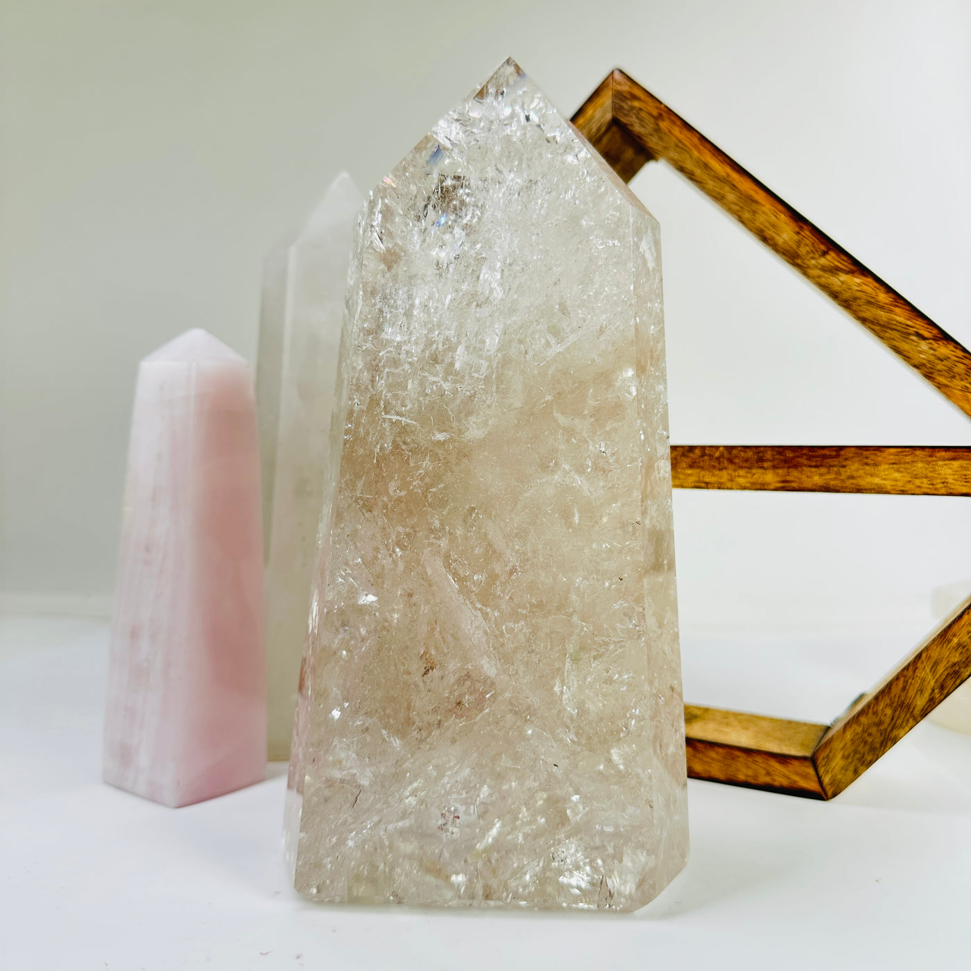 crystal quartz point with decorations in the background