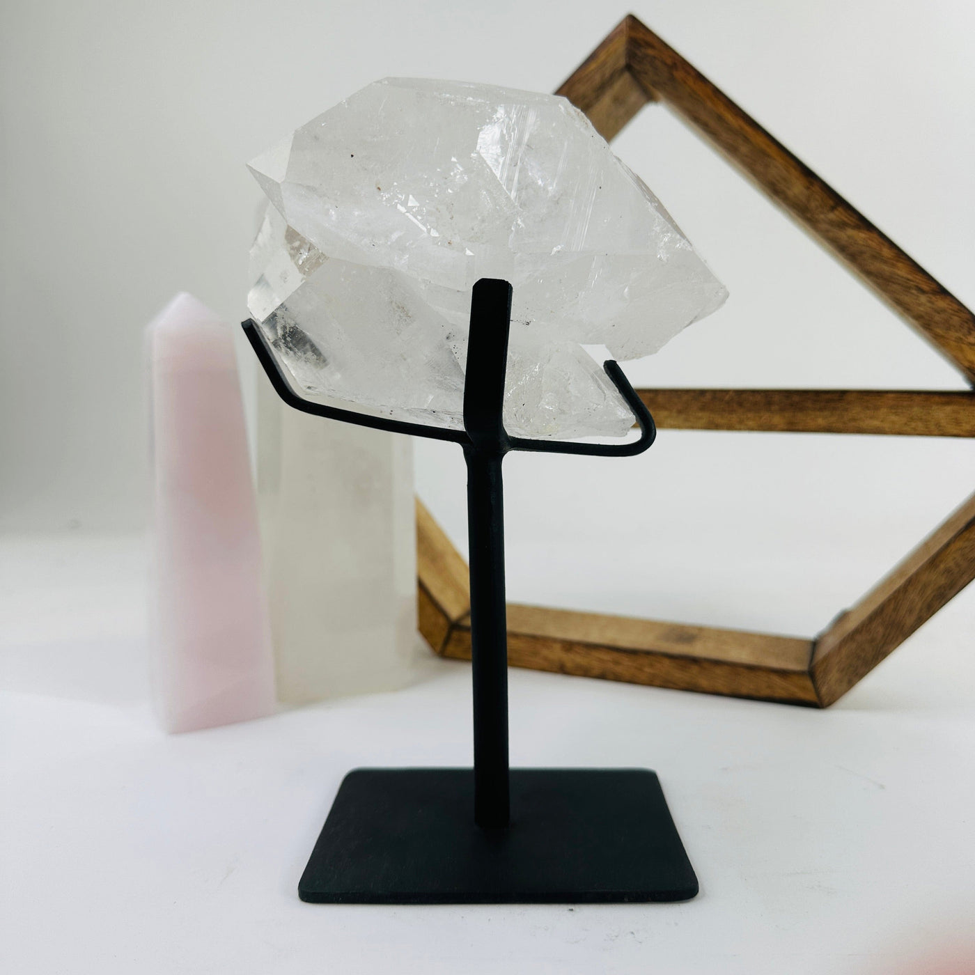 crystal quartz on metal stand with decorations in the background