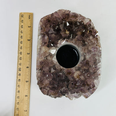 amethyst candle holder next to a ruler for size reference