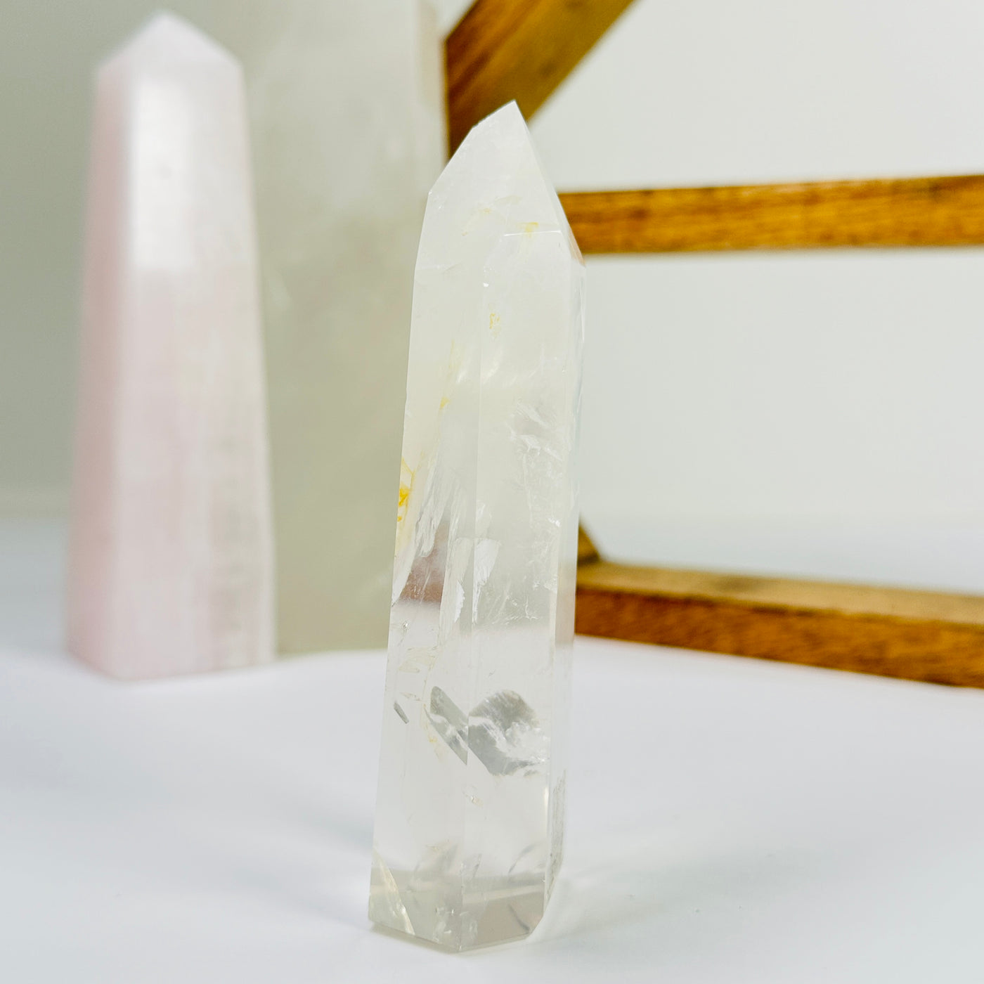 crystal quartz point with decorations in the background