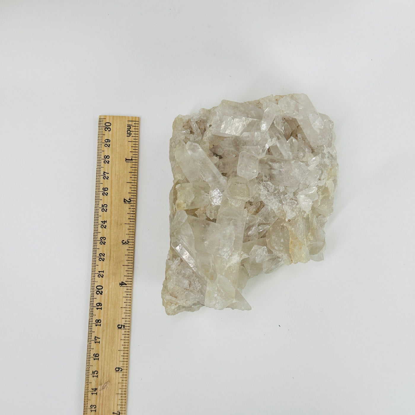 crystal quartz cluster next to a ruler for size reference