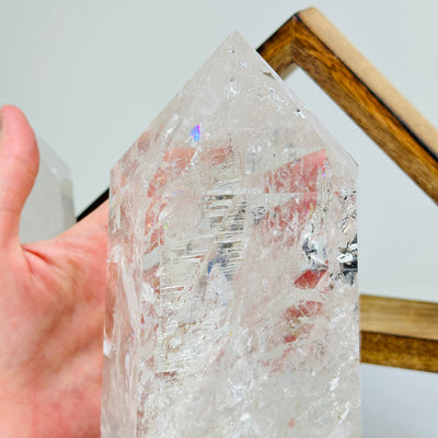 crystal quartz point with decorations in the background