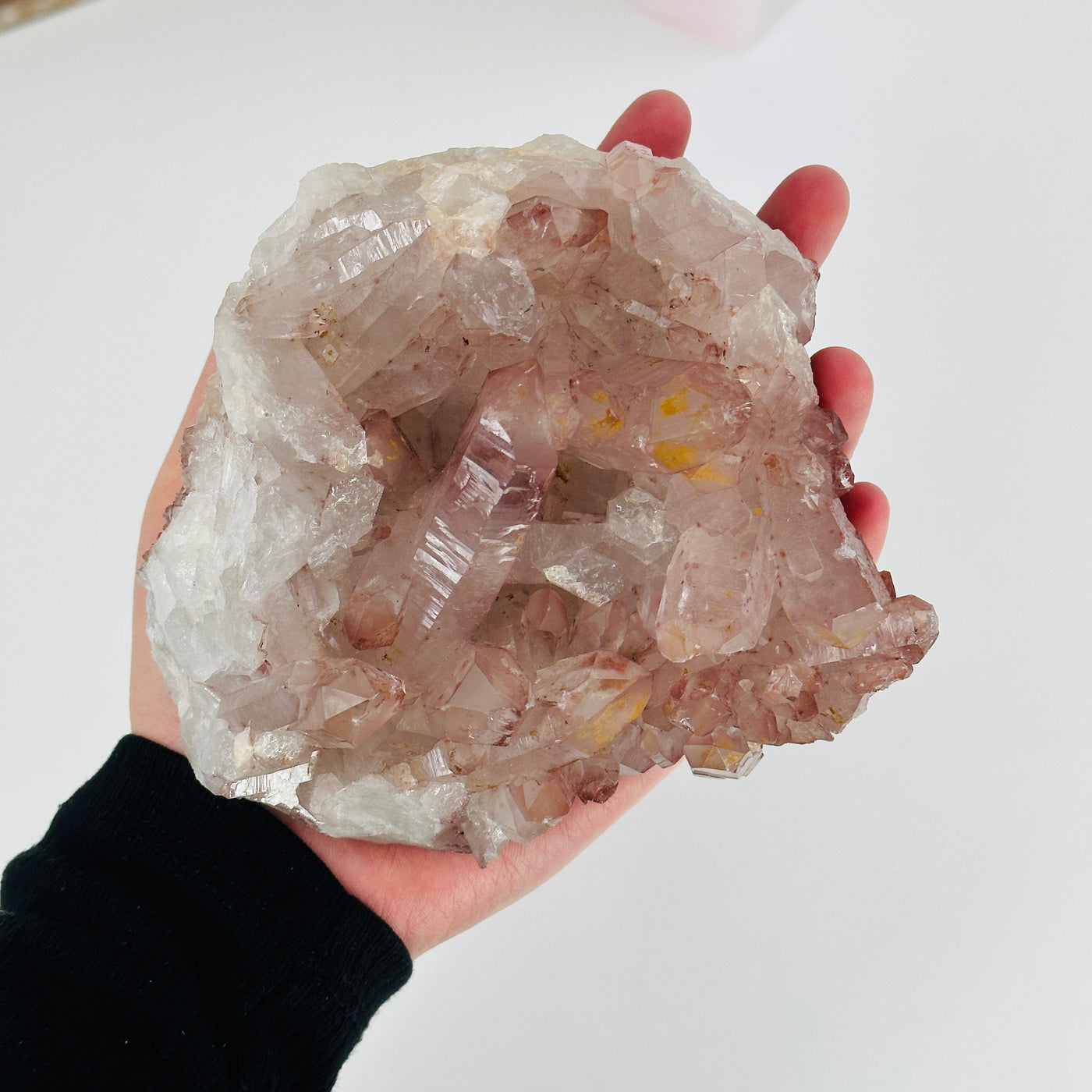 hand holding up lithium quartz cluster