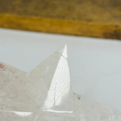 crystal quartz merkaba with decorations in the background