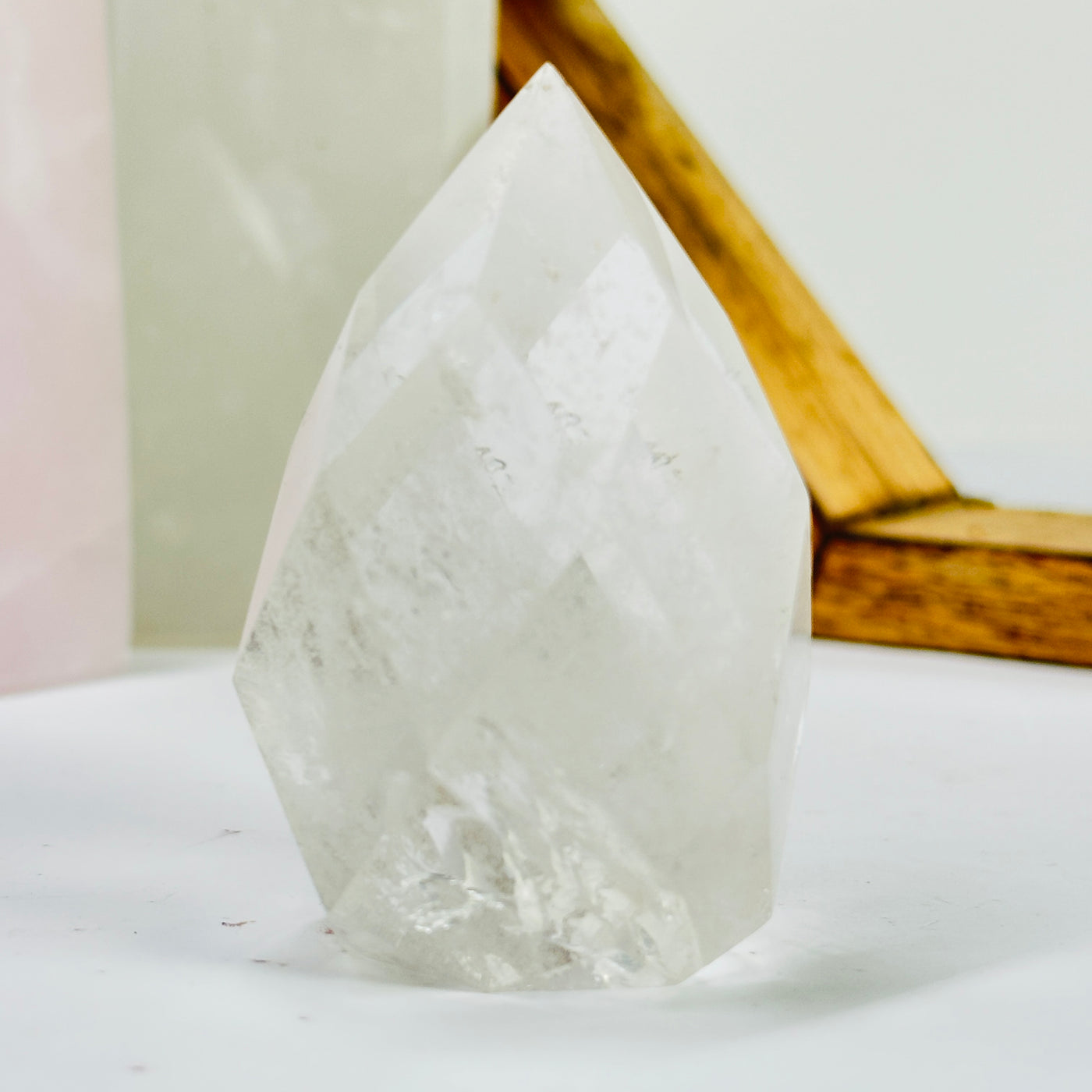 crystal quartz point with decorations in the background