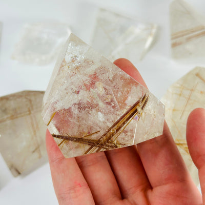 RUTILATED QUARTZ WITH DECORATIONS IN THE BACKGROUND