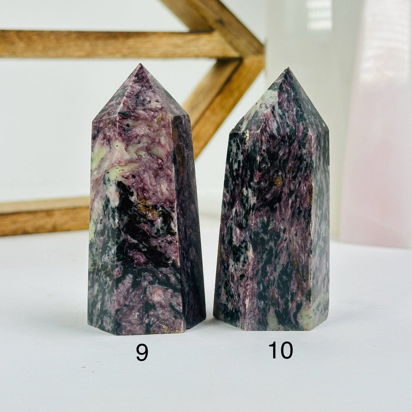 charoite points with decorations in the background