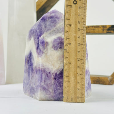 chevron amethyst polished point next to a ruler for size reference