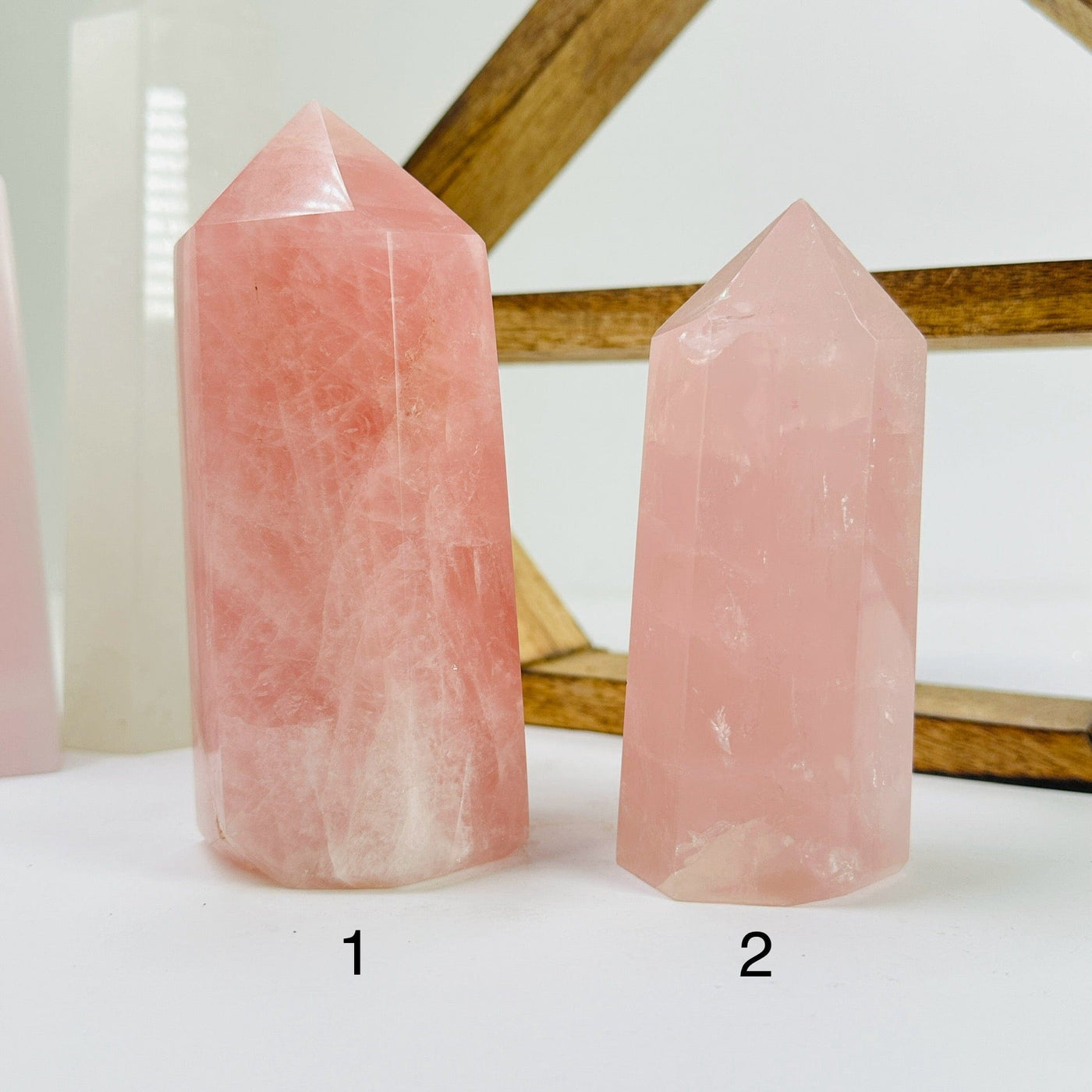 rose quartz point with decorations in the background