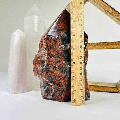 mahogany obsidian point with decorations in the background