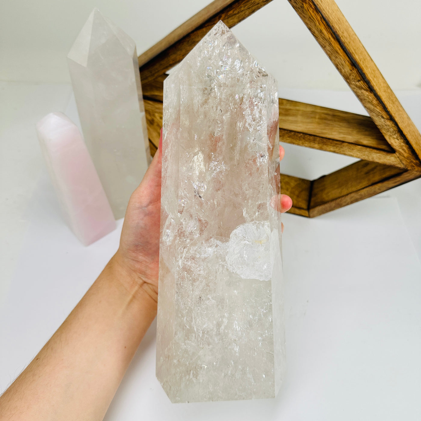 crystal quartz point with decorations in the background