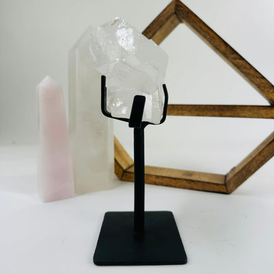 crystal quartz on metal stand with decorations in the background