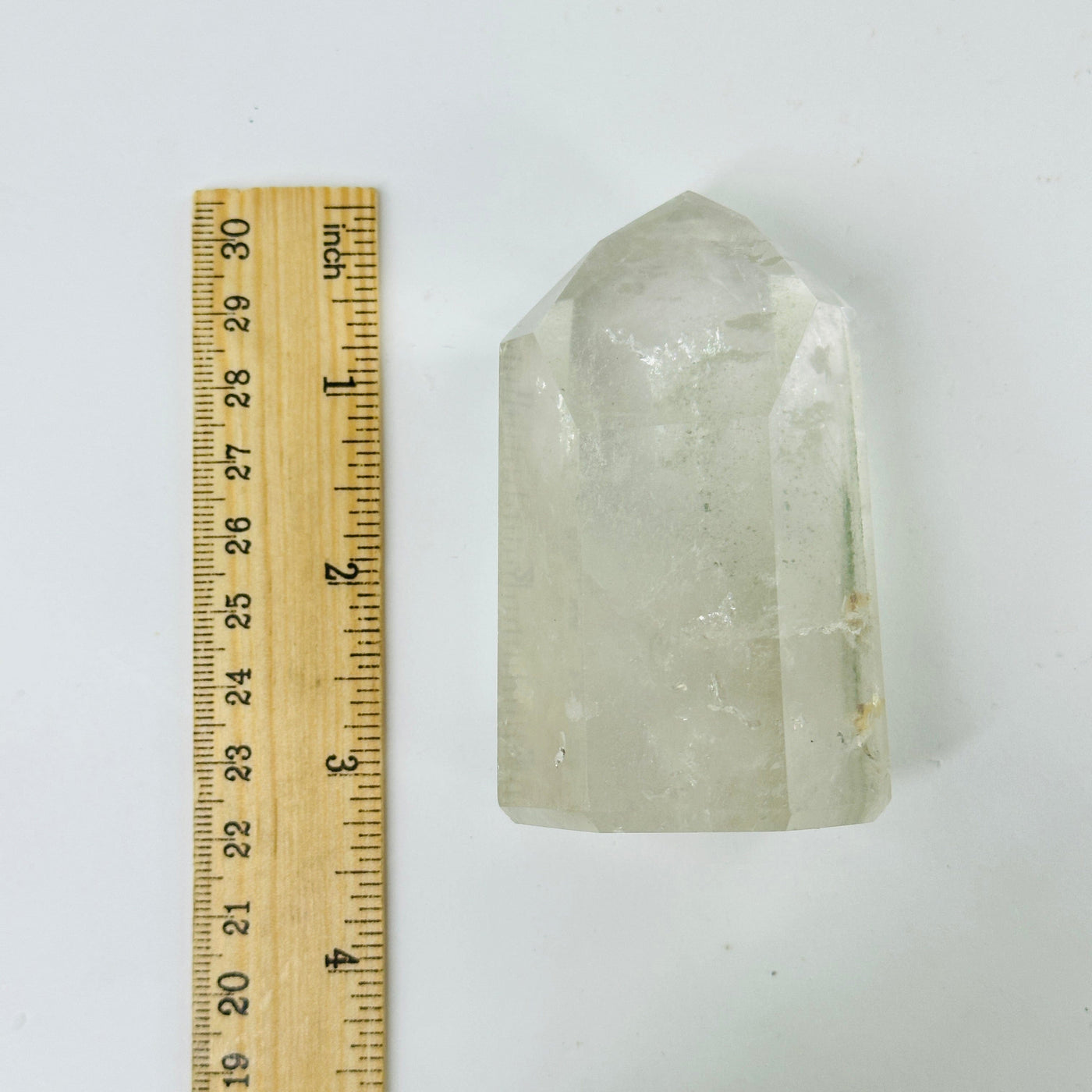 crystal quartz points next to a ruler for size reference