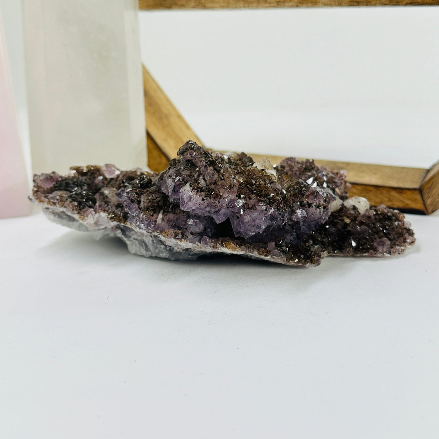 amethyst cluster with decorations in the background