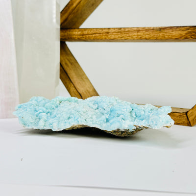 blue aragonite with decorations in the background